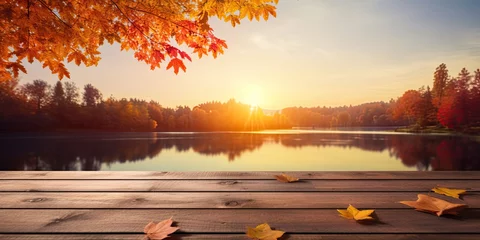 Fototapeten Fall serenity. Tranquil day by lake. Rustic beauty of autumn with wooden table. Sunset glow amidst fall foliage. Lakeside escape © Bussakon