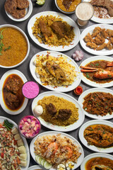 Mutton Bhuna, Jali Kabab, khichuri, Shrimp Biryani, Duck Bhuna Khichuri, hisla Pulao, mutton biriyani, chicken korma, Loitta Fry, Chingri Bhuna, Salad, Fruits Custard top view of bangladesh food