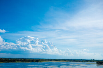 Dark blue sky with white clouds background blue cloud texture Dark blue sky wallpaper with full white clouds and sunlight.