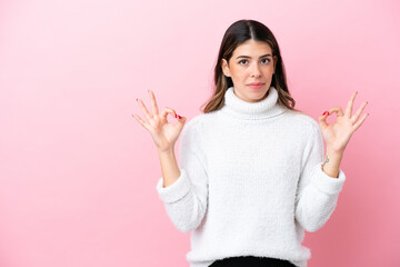 Young Italian woman isolated on pink background in zen pose