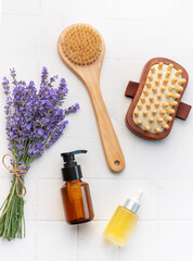 Fototapeta na wymiar Lavender spa. Lavender salt, natural essential oil, massage brushes and fresh lavender
