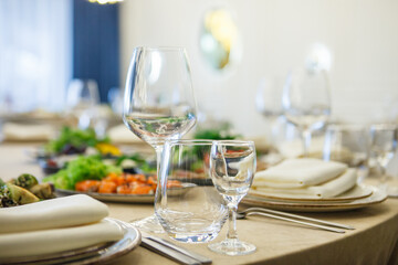 served table, glasses, plates, vase with forge