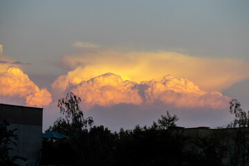 Sunset illuminates cloud formations. Clouds in the form of cotton wool. Yellow tints in the sky....