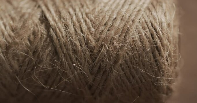 Micro video of close up of spool with brown thread with copy space
