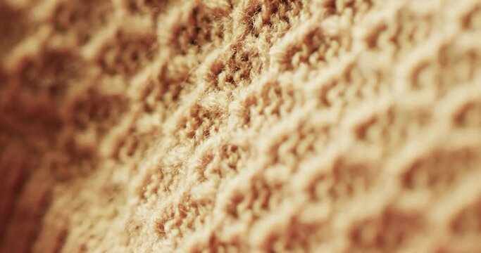 Micro video of close up of yellow wooly crochet fabric with copy space