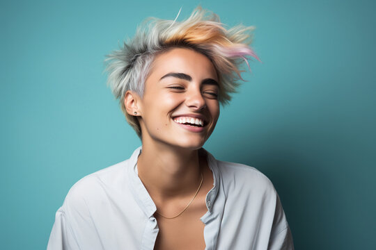 non binary person with short pastel color haircut on a turquoise background, studio shot