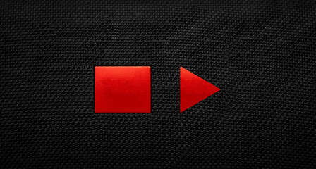 Stop and Play button on a black textile background. Video player.