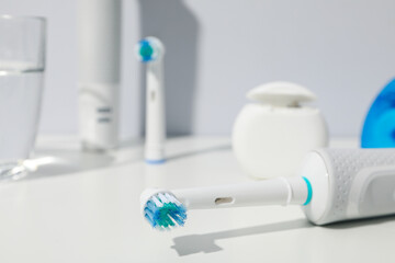 Electric toothbrushes on table on gray background, close up