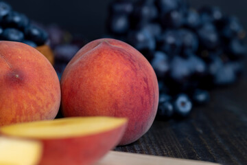 Ripe fresh peaches on a wooden table