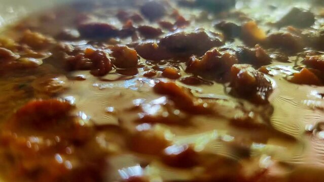 Middle Eastern ful medames fava bean mashed up closeup steam rising breakfast meal inspired by Lebanese with tahini olive oil lemon juice garlic and some salt