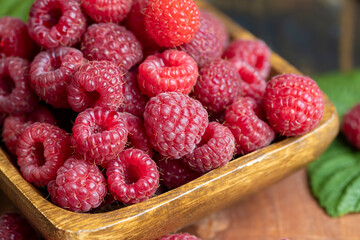 Ripe raspberries on a wooden board