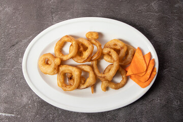 Fried onion rings served in dish isolated on background top view of bangladesh food