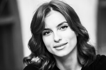 Close up portrait of a beautiful young woman smiling and looking at camera. White European girl with beautiful smile