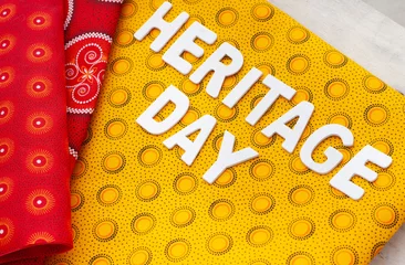 Deurstickers Heritage Day South Africa. Heritage Day written in white letters with iconic South African printed cloth © Aninka