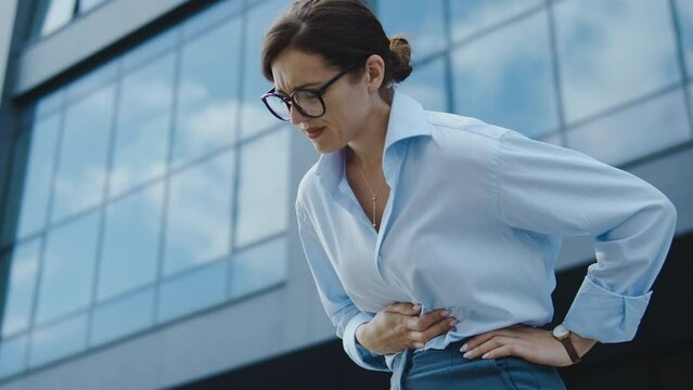 Business woman feeling unpleasant pain in stomach, crumps and nausea, gastritis