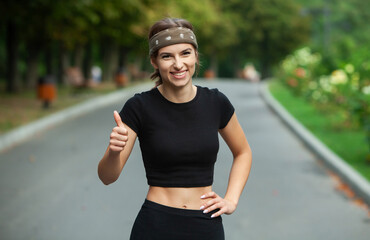 Athletic young woman in sportswear jogging in the park. Fitness and healthy lifestyle. Portrait of a beautiful young woman in sportswear outdoors. Sport fitness model caucasian ethnicity training outd