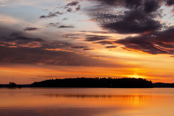Naklejka na ściany i meble Sunset over finnish landscape with water and forest in summer at Lake Saimaa, Karelia, Finland