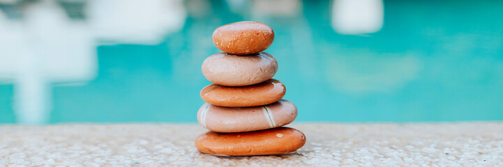 pyramid of stones by the sea at dawn, balanced zen stones, spa and relax concept, meditation