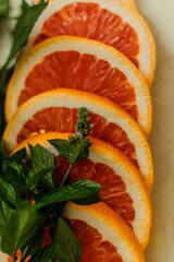 sliced red orange with sprigs of green mint