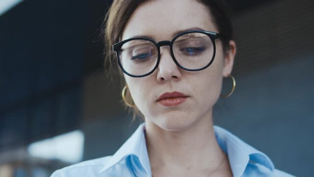 Sad student girl standing near university building, expelled for absenteeism