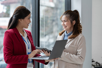 Manager or supervisor with two asian businesswoman having a discussion communication Negotiate project documents Analyze the marketing plan. business investment in finance, tax, office interior