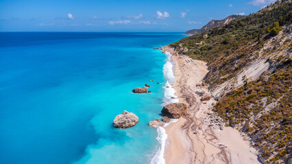 Fototapeta na wymiar Aerial drone view on paradise sandy Megali Petra beach in Lefkada. Beautiful crystal clear turquoise and blue waters. Greece