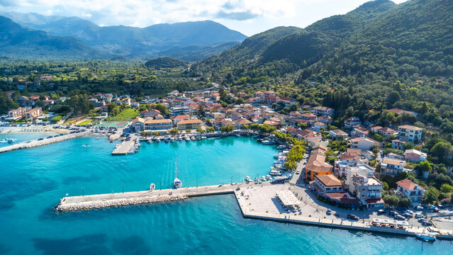 Aerial view of the port of the coastal village of Vasiliki in the south of the island of Lefkada, Greece. Beautiful crystal clear turquoise and blue waters