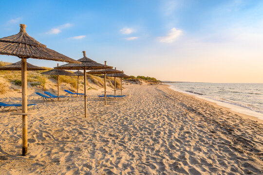 Straw umbrellas on sandy beach of Marmari. The Greek island of Kos