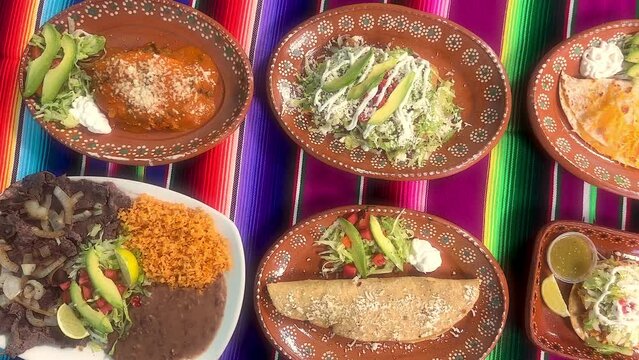 Group of Mexican food dishes on table