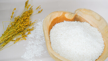 Top view of rice in wooden bowl on white background
