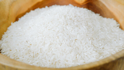 Top view of rice in wooden bowl on white background