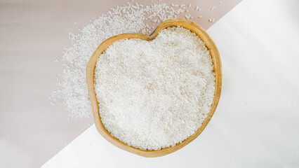 Top view of Paddy rice and white rice in wooden bowl on white background