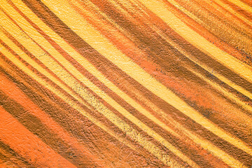 Colorful abstract brush strip drawing on the walls of the city. Striped pattern for wallpaper design. Beautiful bright colorful street art graffiti background.