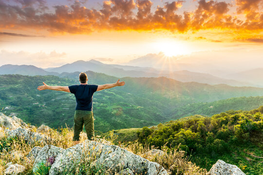 Happy Man Watching Amazing Highland Evening Sunset, Person Delight With Nature Landscape