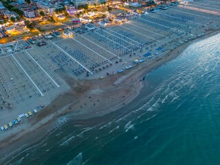 Sandy beach on the Adriatic Sea at sunset, view from a drone. Summer vacation, tourism and travel...