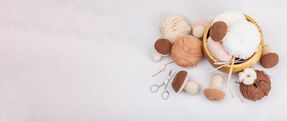 Fototapeta na wymiar Set of clew of thread for knitting. Crocheted mushrooms, handmade, hobby concept. Props