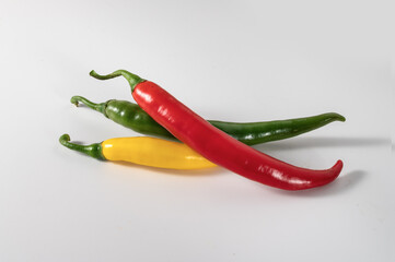 Chili peppers in 3 colours on white isolated