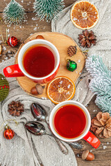 Winter cozy composition with hot tea and traditional Christmas decoration. New Year balls