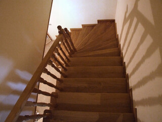 Wooden steps with traditional balusters indoors.