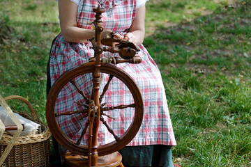 Young woman using a spinning wheel