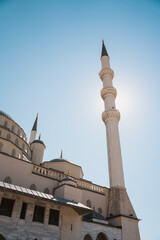 Fototapeta na wymiar Ankara Kocatepe Mosque minaret silhouette from below with blue sky in sunny weather