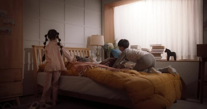 Happy Korean Family in the Morning: Active and Playful Children Running to Their Parents' Bedroom to Wake Them Up. Excited Kids Forcing Their Parents Out of Bed to Have a Fun Weekend Together