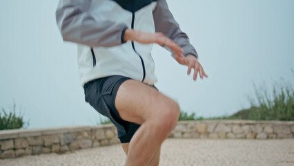 Closeup athlete legs training in city park. Professional sportsman body training