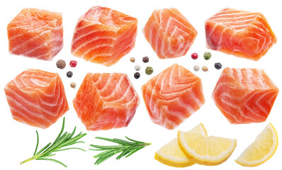 Fresh salmon cubes or salmon pieces with spices and lemon slices on white background. File contains...