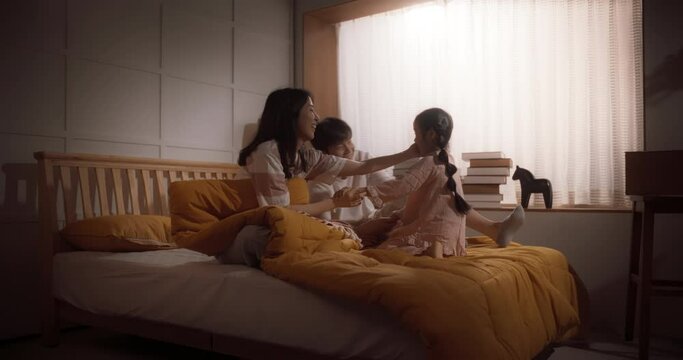 Active And Playful Child Waking Her Parents Up To Face A New Day. Korean Family Getting Ready For A Happy Day, Excited Little Girl Forcing His Parents Out Of Bed To Start Getting Ready For School