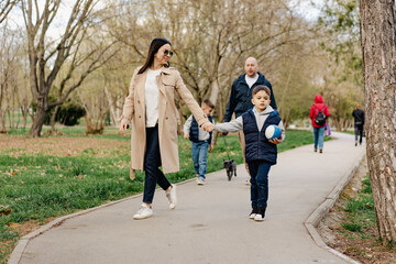 Fototapeta premium Happy family on a walk in the park