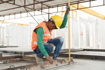 Fototapeta premium Asian male builder worker working at construction site. Male mason working at construction site