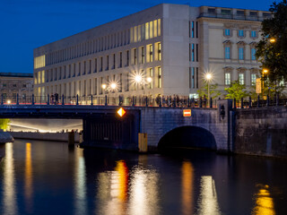 View of Berlin city river at dusk. Light trails along the river from evening lanterns.