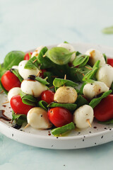 A plate with Italian salad caprese canape
