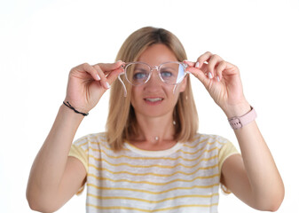 Portre young woman with poor eyesight holds glasses in hands. Selection of glasses for vision...
